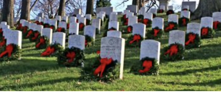Wreaths Across America Gravestones in a line with wreaths in front of each